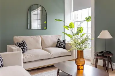 a living room with a couch and a table at Dragon Suites Luxury Serviced Apartments at Walker Street in Edinburgh