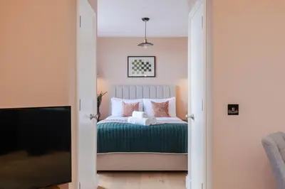 a bedroom with a bed and a tv at Dragon Suites Luxury Serviced Apartments at Walker Street in Edinburgh
